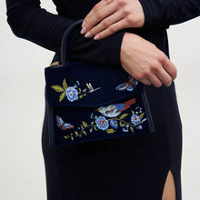 Load image into Gallery viewer, Fable Embroidered Bird & Floral Velvet Mini Grab Bag – Navy (on wrist)