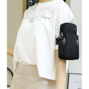 Black Heart Zip Puller Showerproof Essential Phone Bag (on arm)